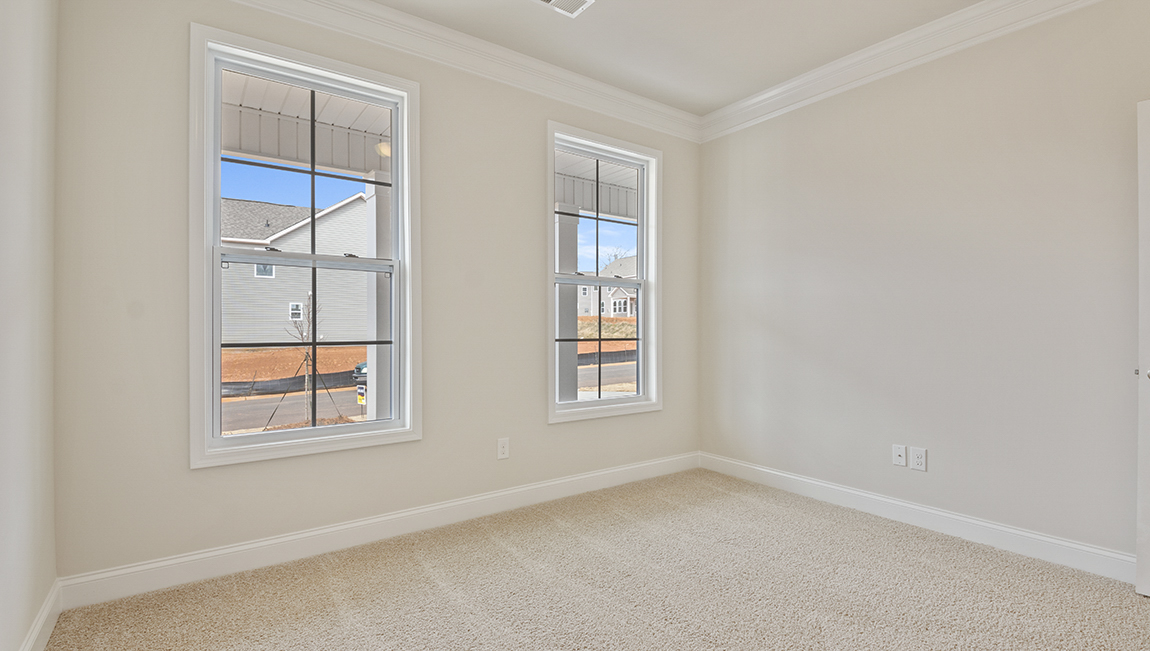 Carpeted bedroom with two windows