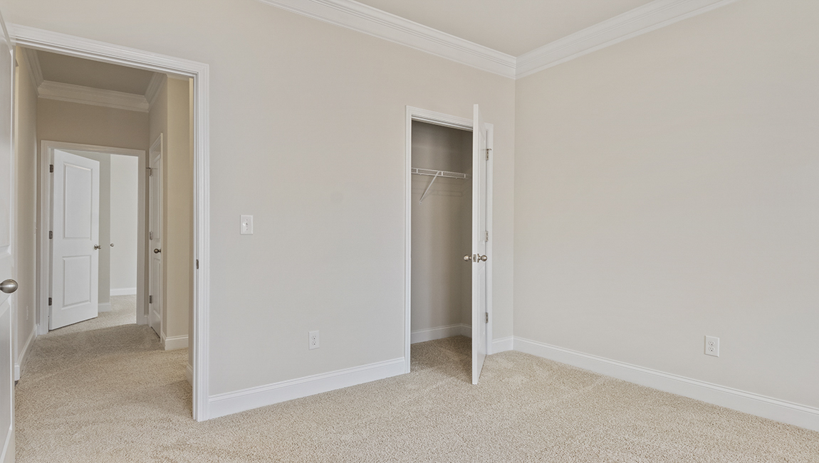 Carpeted bedroom with two windows