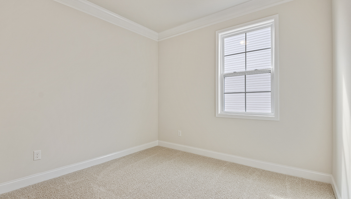 Carpeted bedroom with two windows