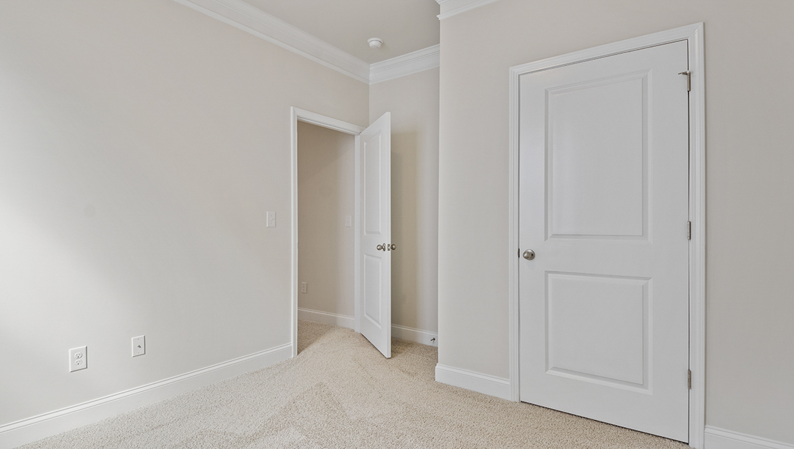 Carpeted bedroom with two windows