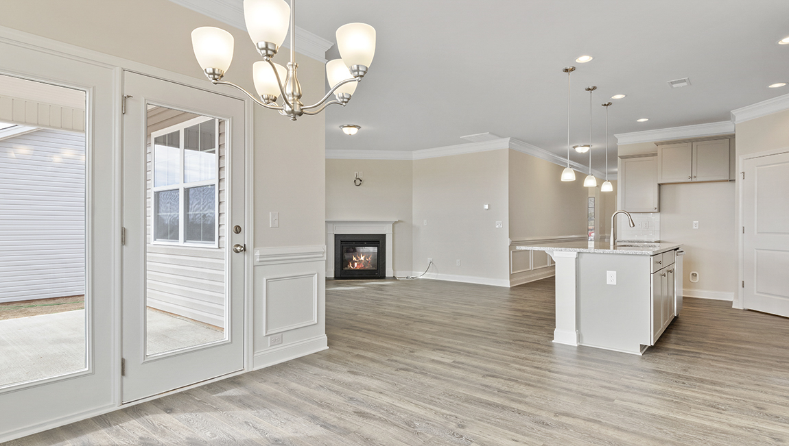 Kitchen and island, white counters and cabinets, wood floors