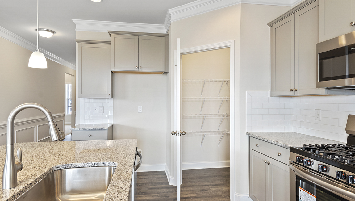 Kitchen and island, white counters and cabinets, wood floors