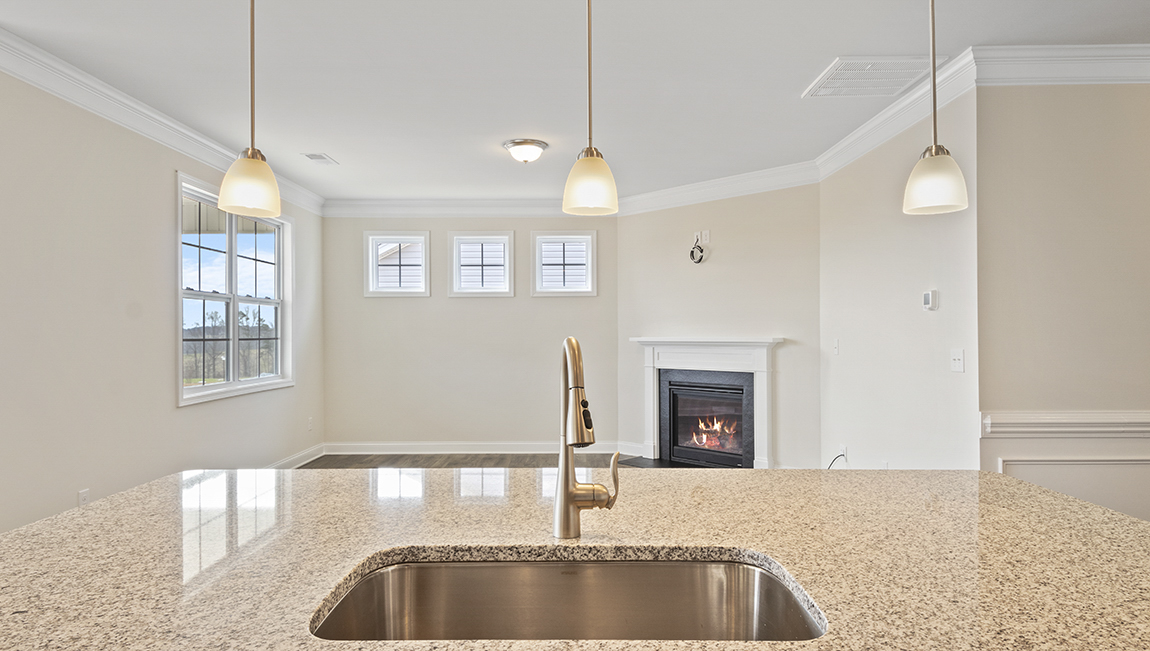 Kitchen and island, white counters and cabinets, wood floors