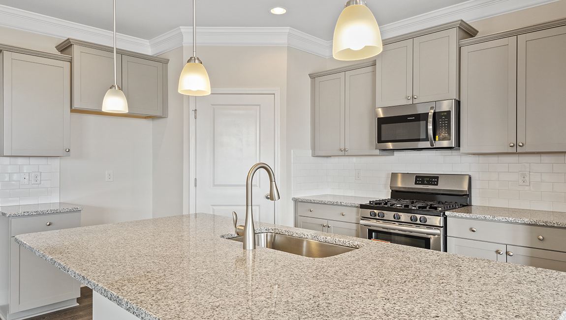 Kitchen and island, white counters and cabinets, wood floors