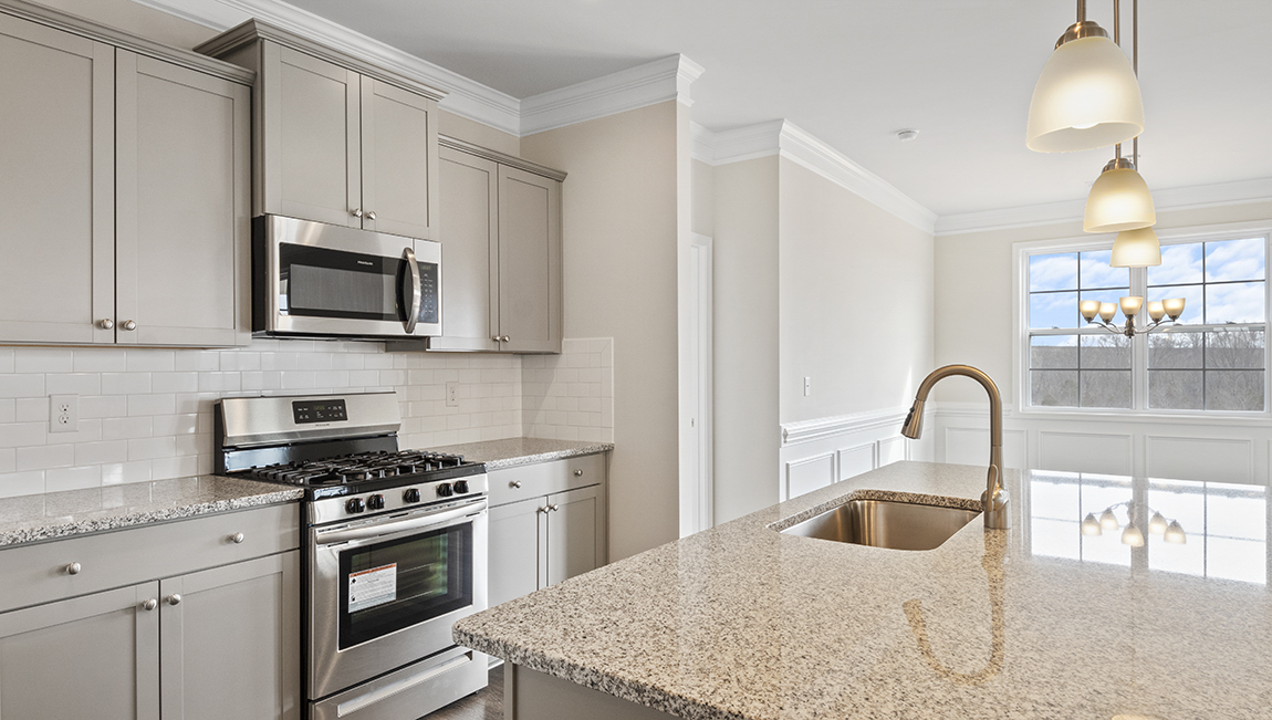 Kitchen and island, white counters and cabinets, wood floors