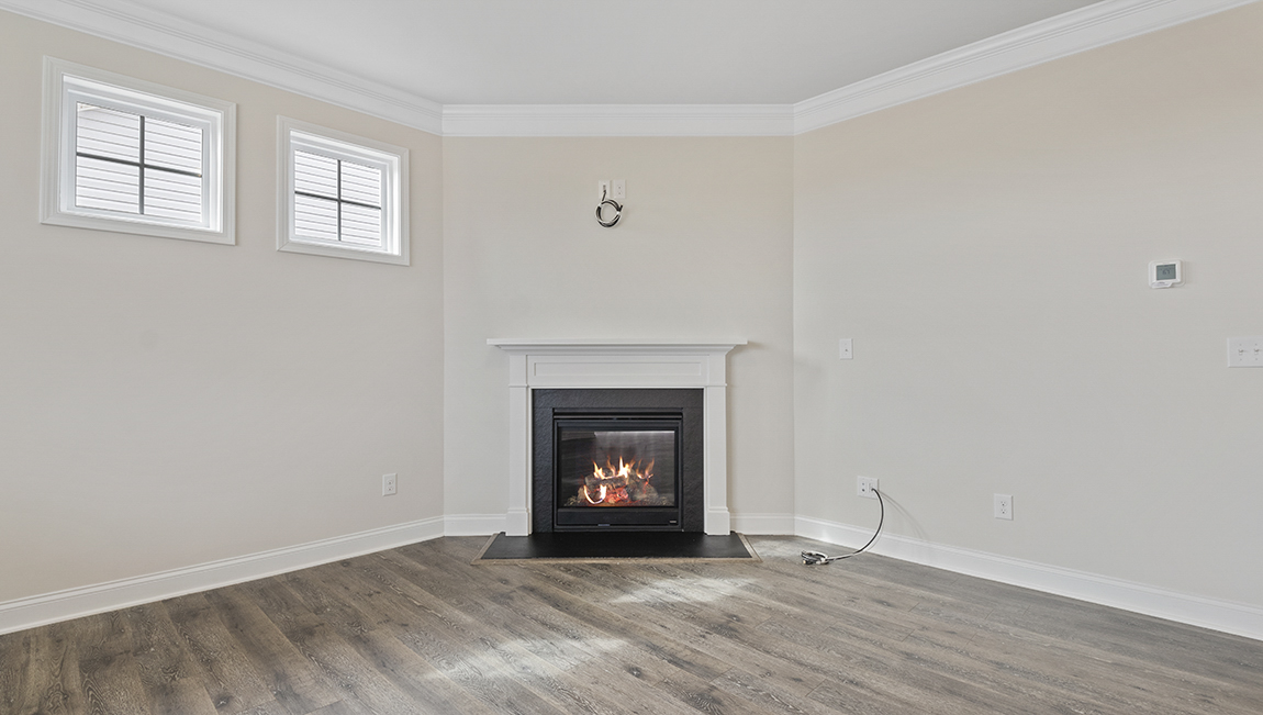 Living room space with large window and fireplace