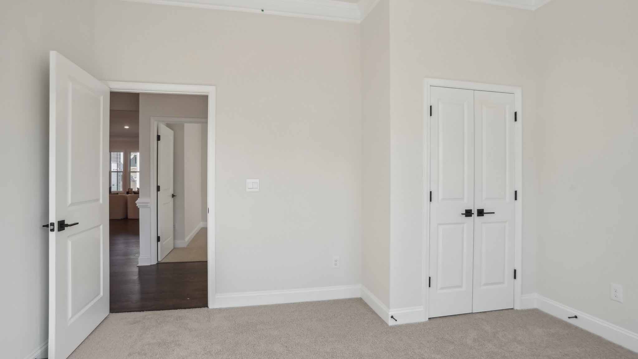 Carpeted bedroom three large windows