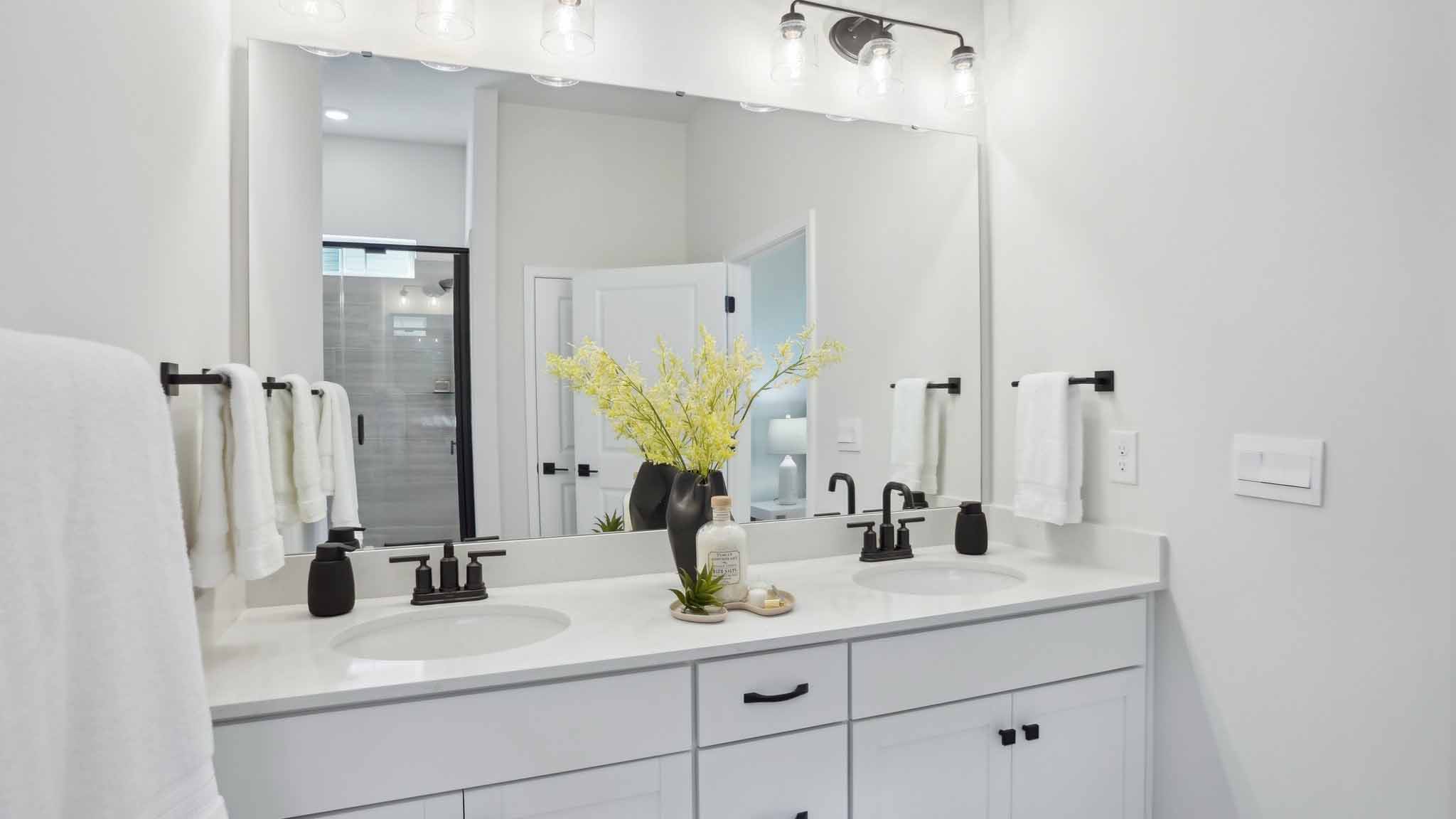 Bathroom with bathtub, white cabinets and counters