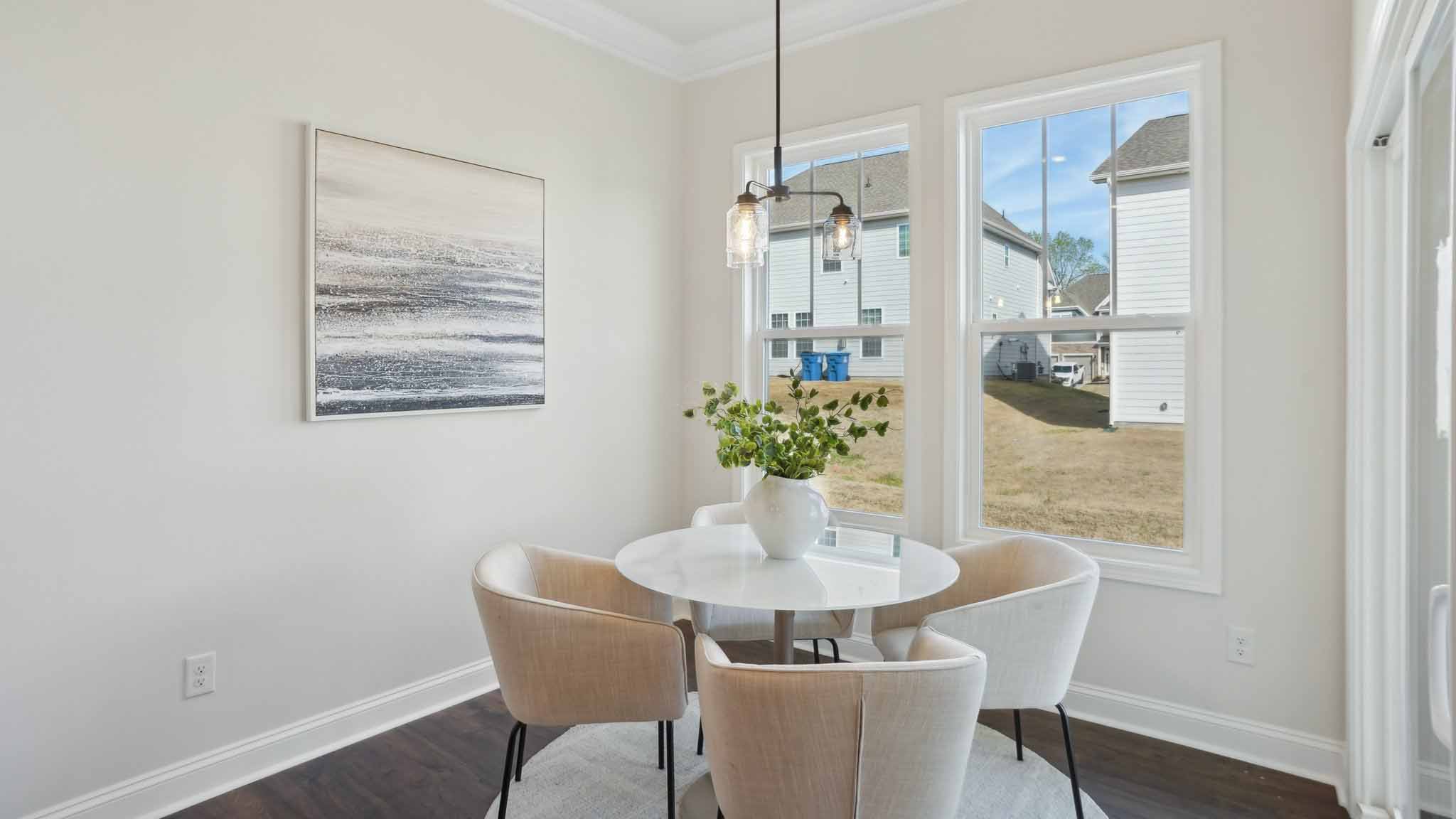 Breakfast area with wood floors, and surrounded by large windows