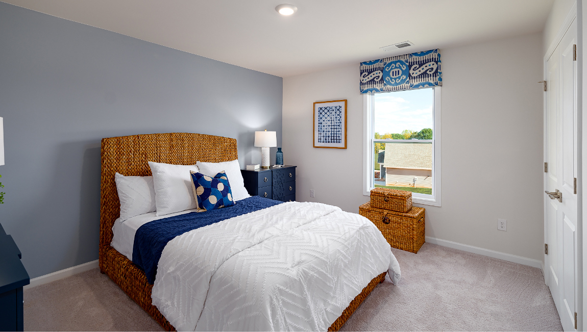 Carpeted bedroom three large windows