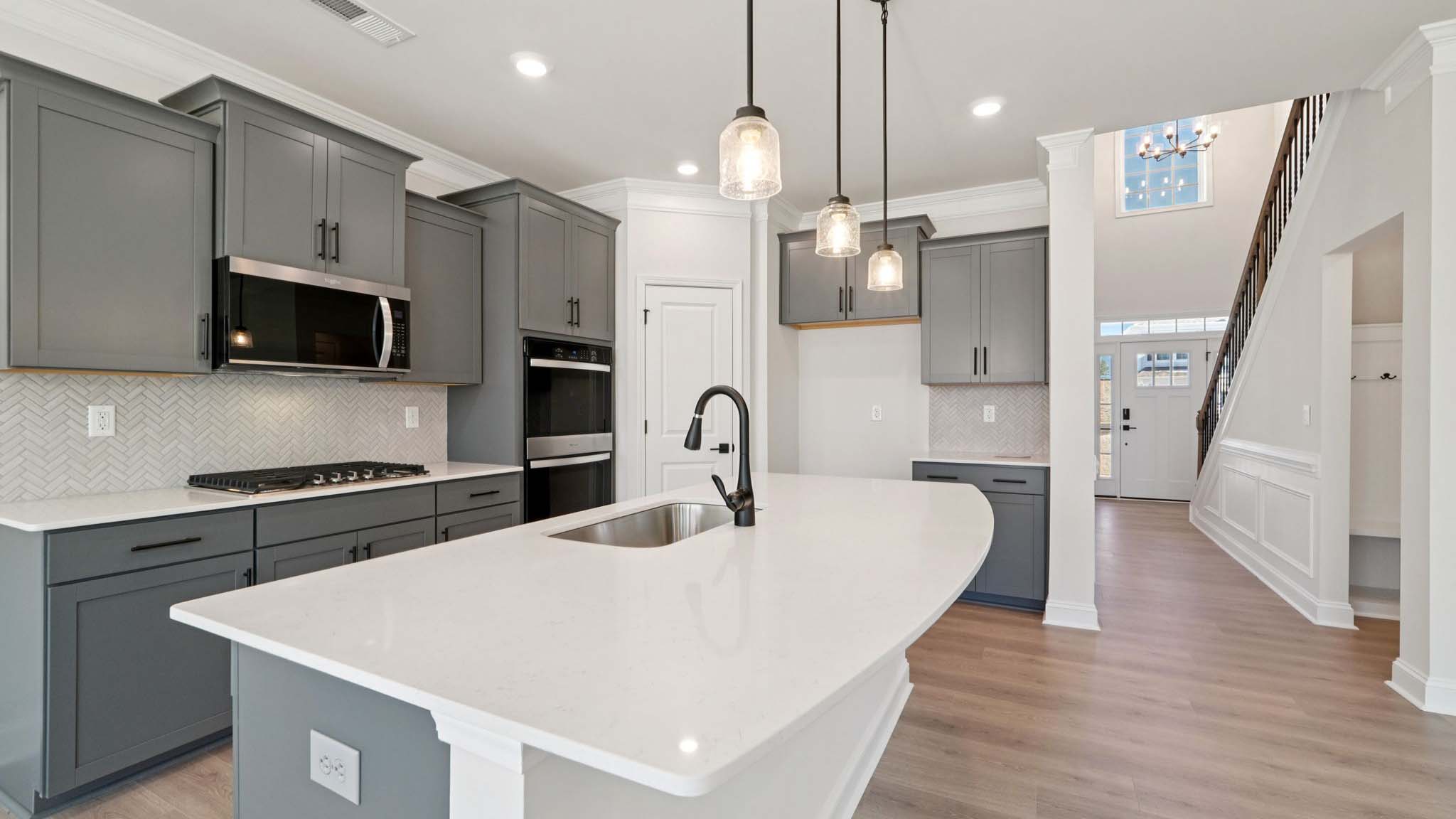 Kitchen and island with stainless steel appliances