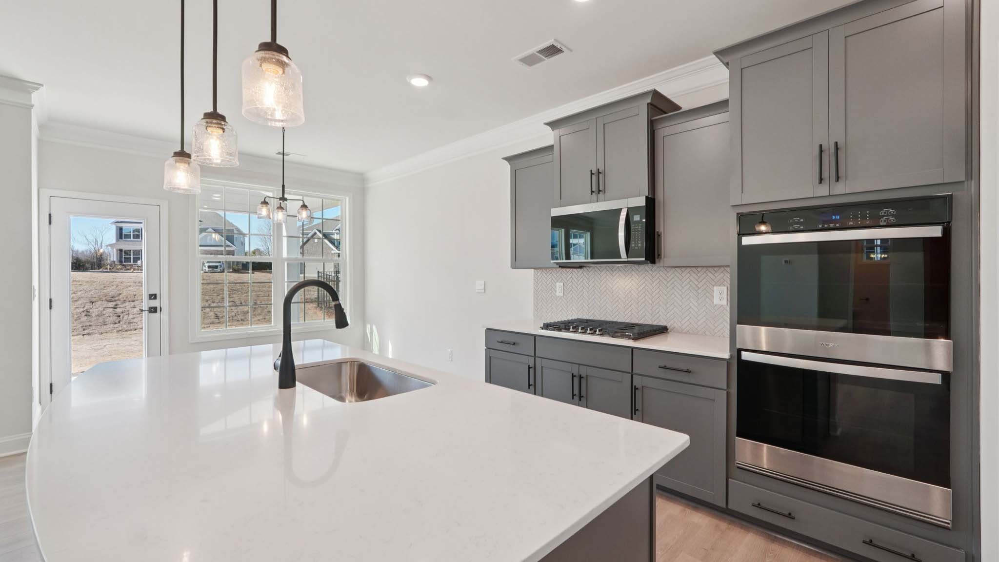 Kitchen and island with stainless steel appliances