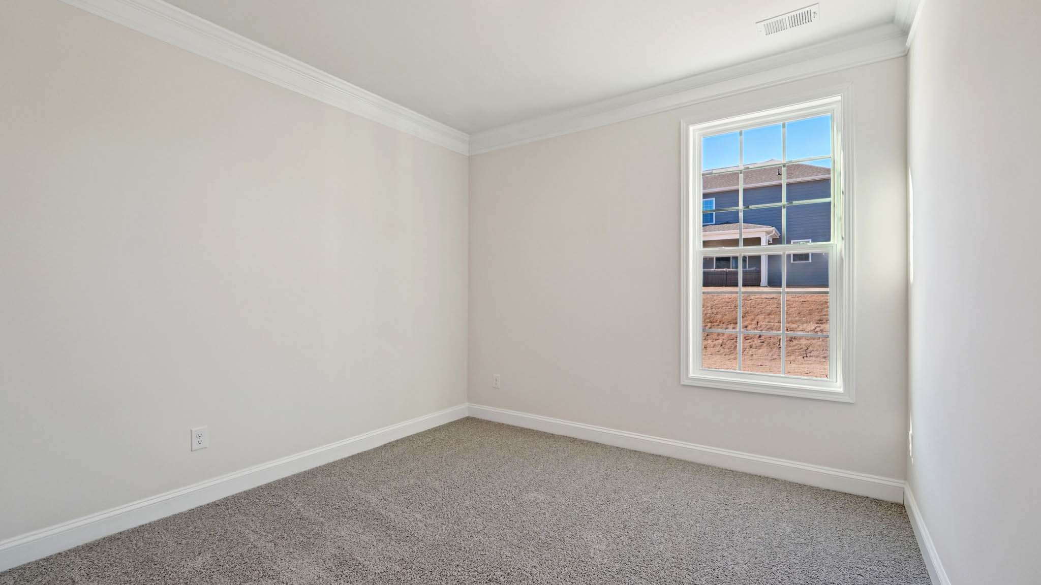 carepeted bedroom with small window