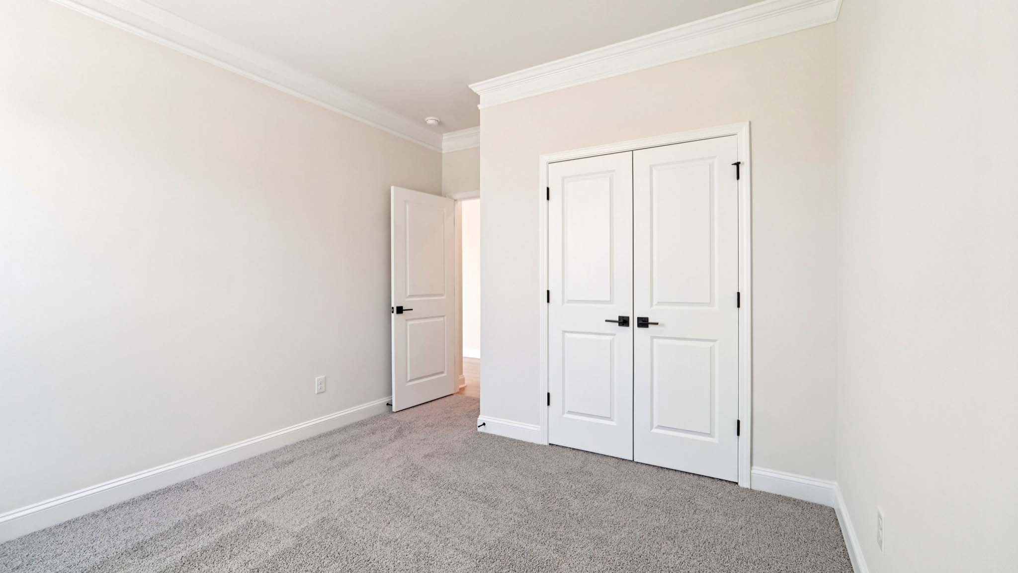 carepeted bedroom with small window