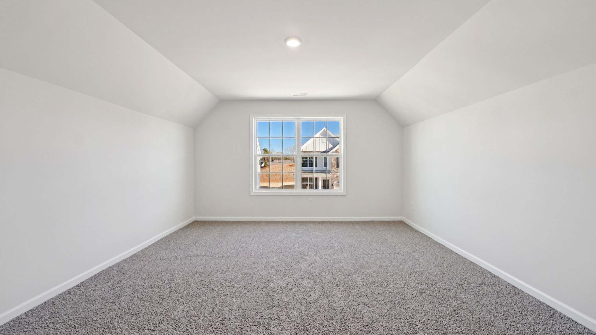 carepeted bedroom with small window