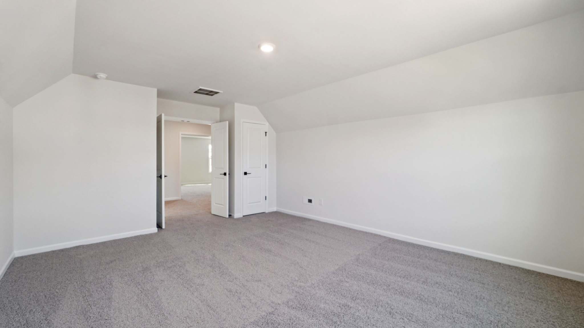 carepeted bedroom with small window