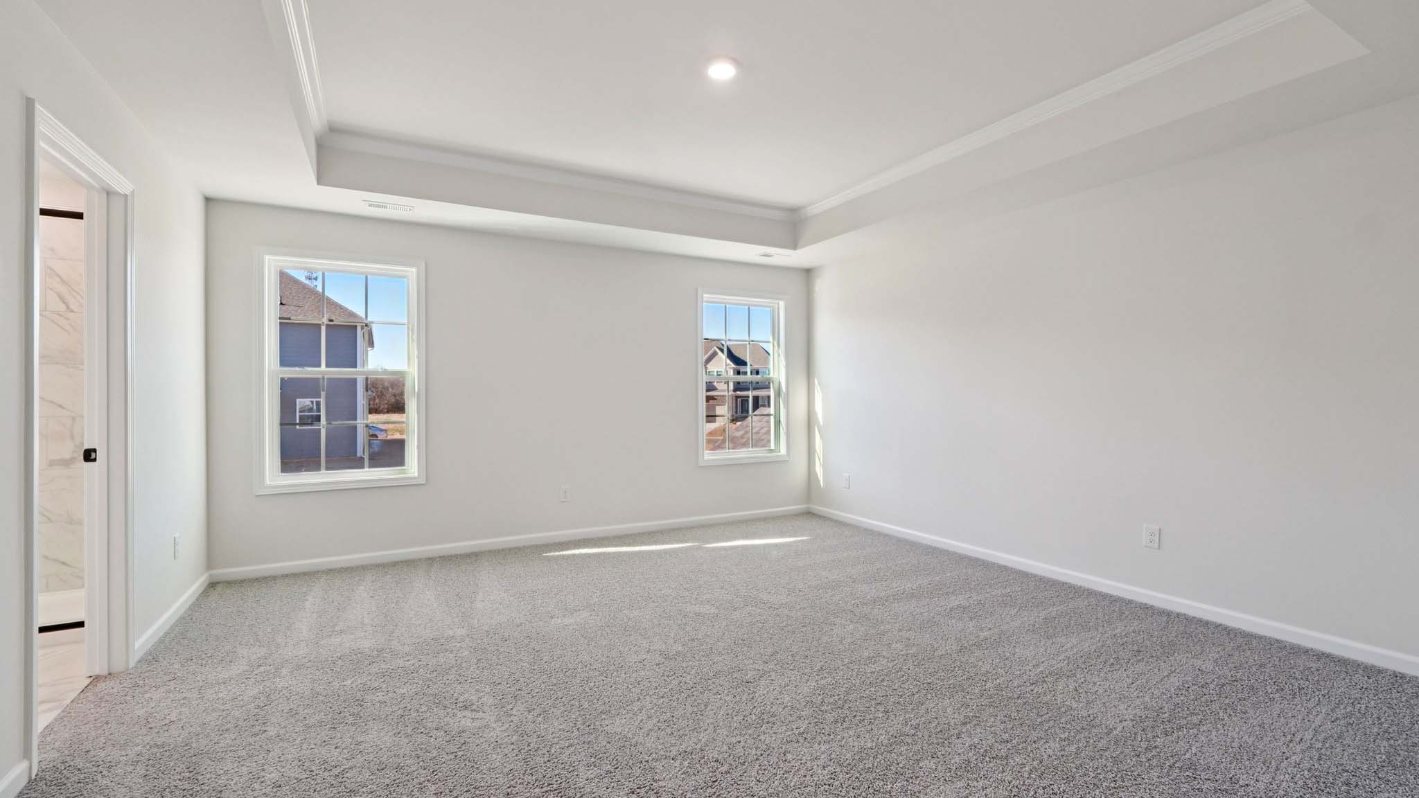 carepeted bedroom with small window