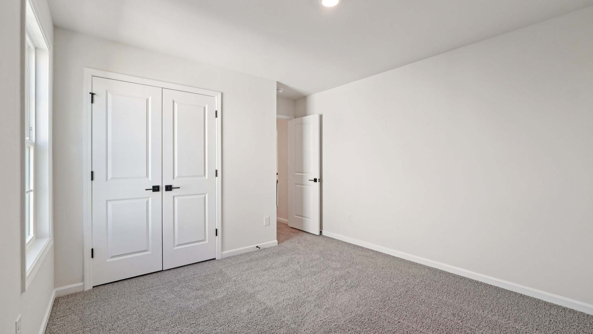 carepeted bedroom with small window