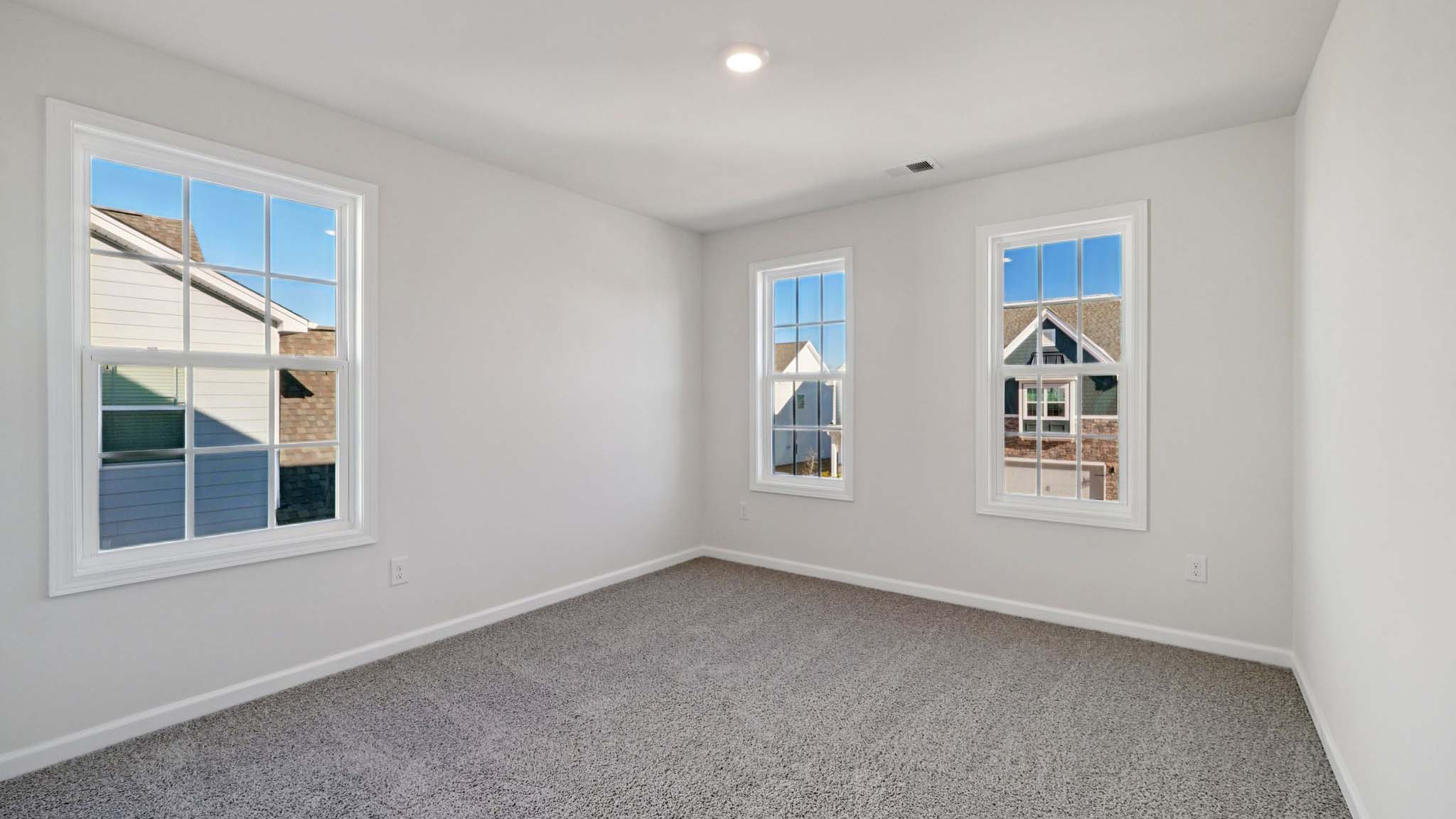 carepeted bedroom with small window