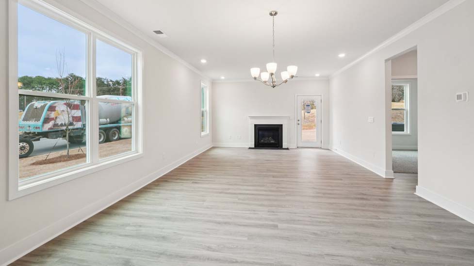 Living room space with large window and fireplace