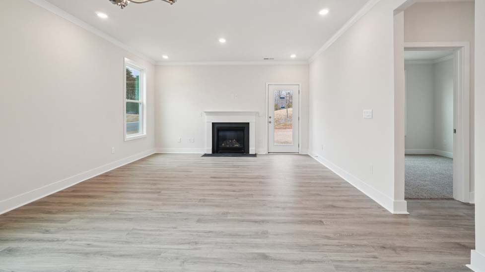 Living room space with large window and fireplace