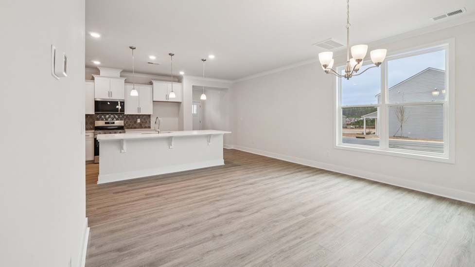 Living room space with large window and fireplace