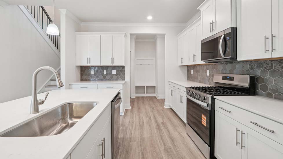 Kitchen and island, white counters and cabinets, wood floors