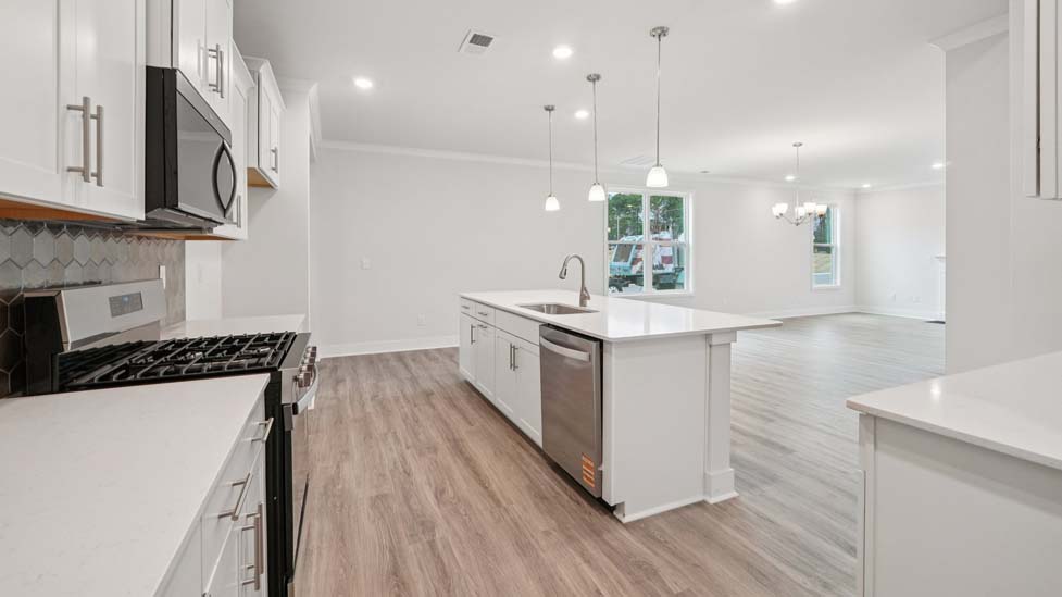 Kitchen and island, white counters and cabinets, wood floors