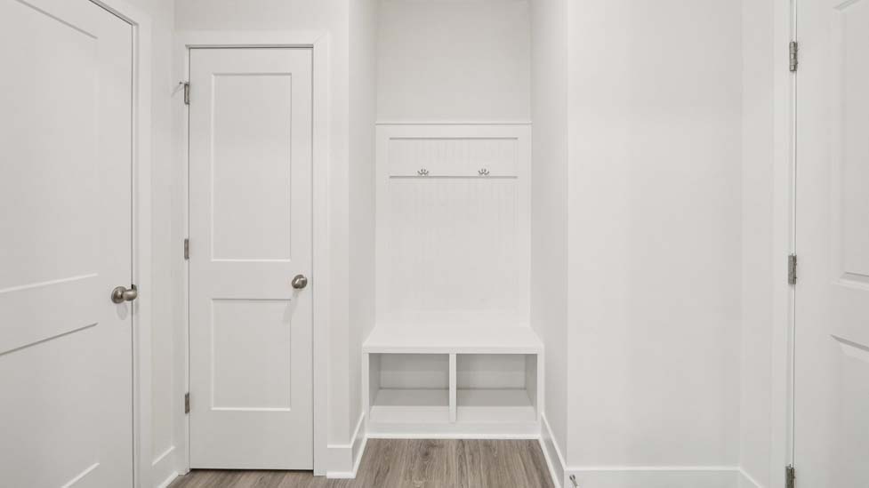 Kitchen and island, white counters and cabinets, wood floors