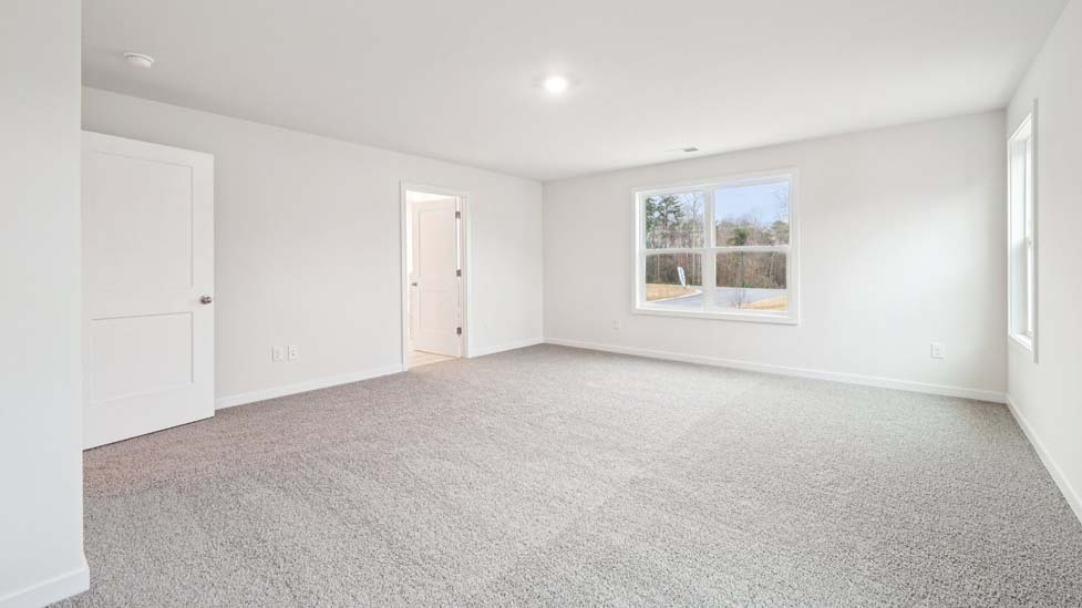 Primary bedroom, wood floors, large windows