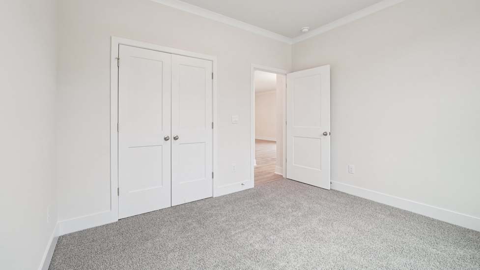 Carpeted bedroom with two windows