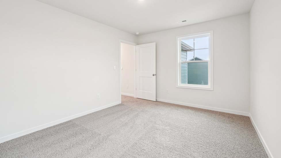 Carpeted bedroom with two windows