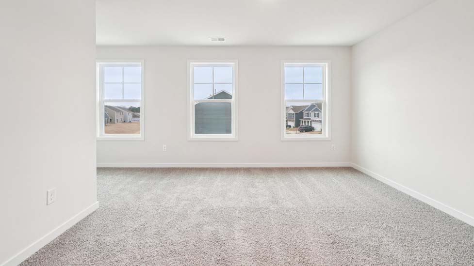 Carpeted bedroom with two windows