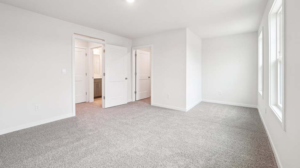 Carpeted bedroom with two windows