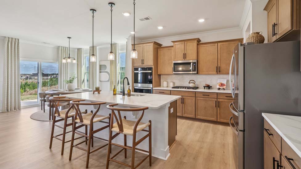 Kitchen and island with stainless steel appliances