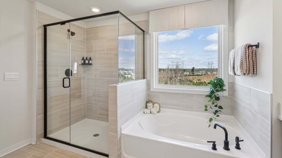 Primary bathroom with double sinks and standing shower