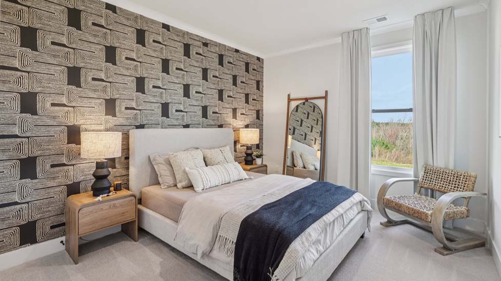 Carpeted bedroom with windows