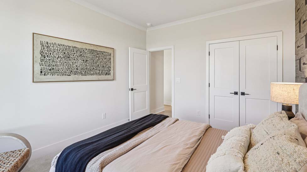 Carpeted bedroom with windows