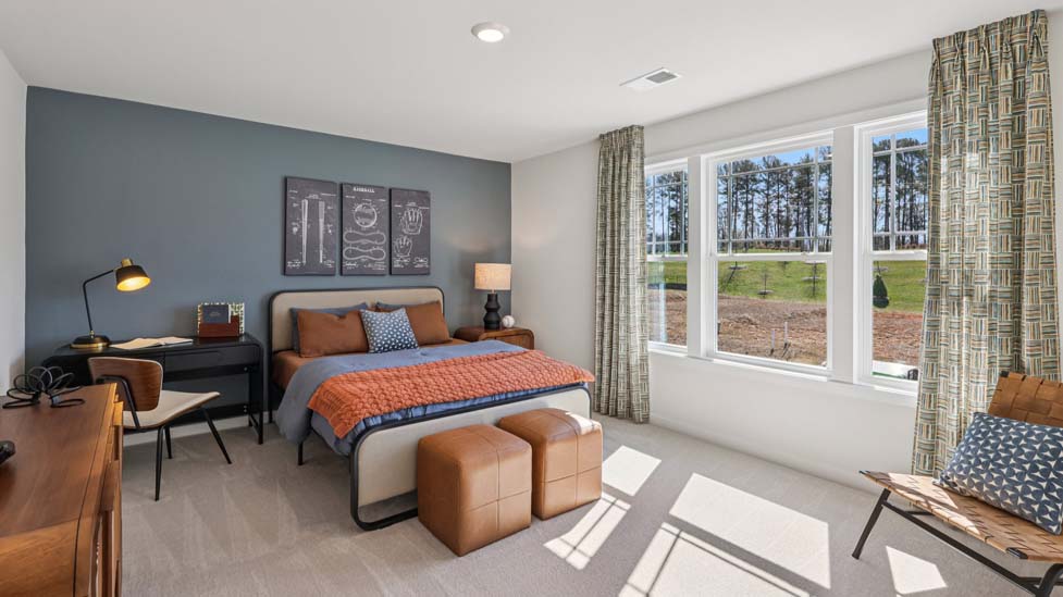 Carpeted bedroom with windows