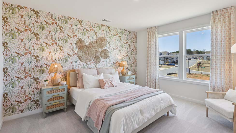 Carpeted bedroom with windows