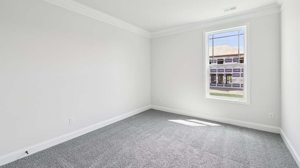 Carpeted bedroom with windows
