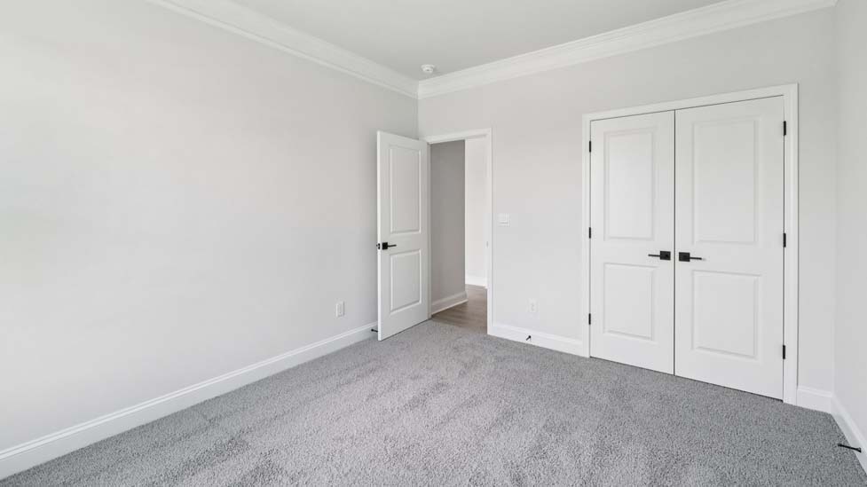 Carpeted bedroom with windows