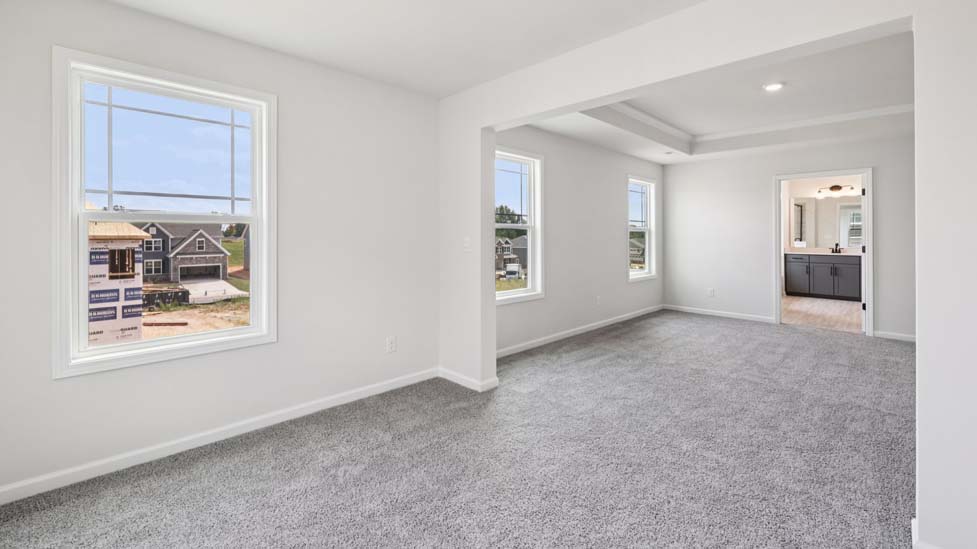 Carpeted bedroom with windows