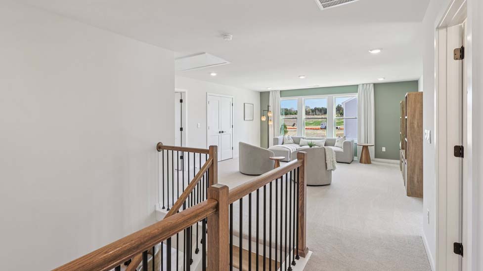 Carpeted upstairs landing with loft