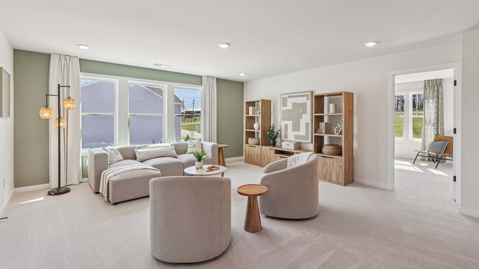 Upstairs carpeted loft with large windows