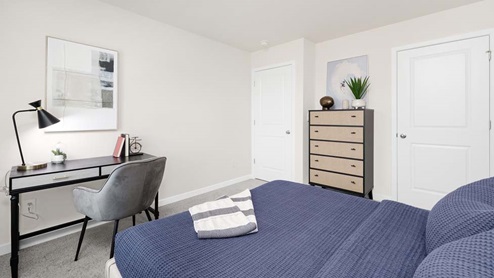 Carpeted bedroom with large windows