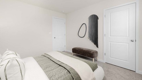 Carpeted bedroom with large windows