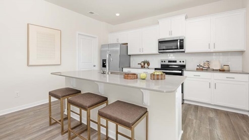 Kitchen and island with stainless steel appliances
