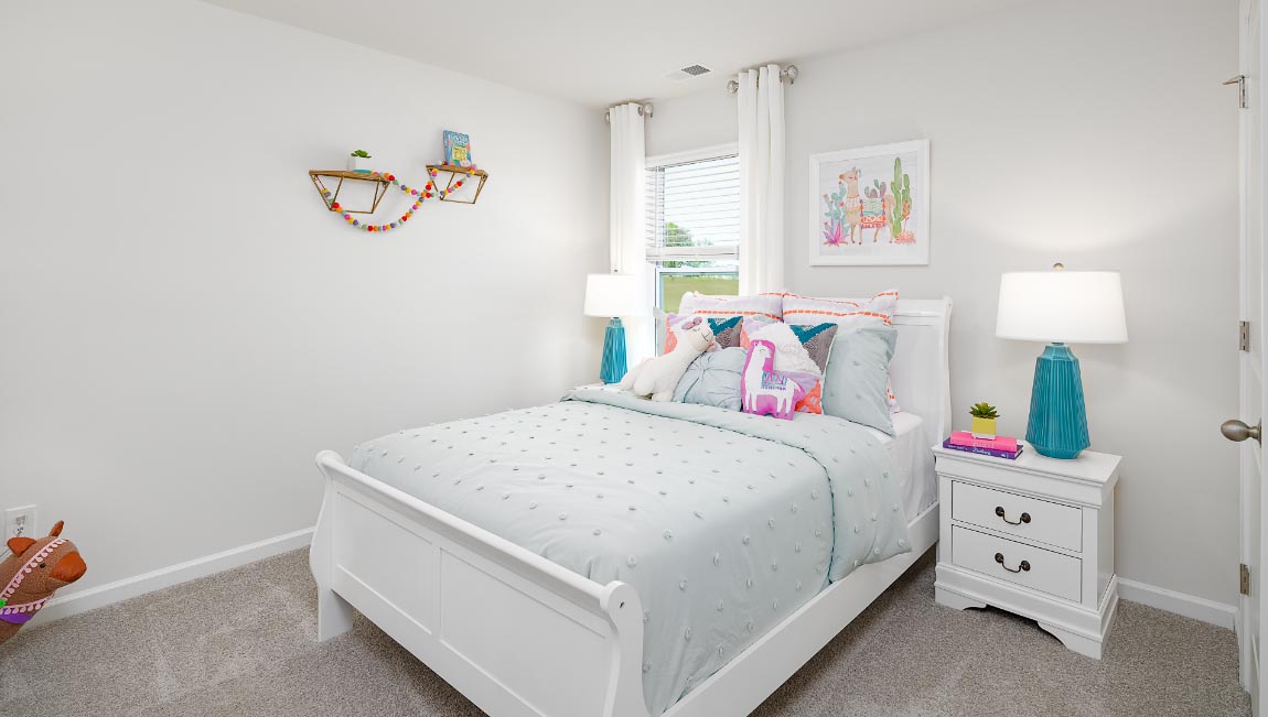 Carpeted bedroom with large window. New Home in Charlotte, North Carolina