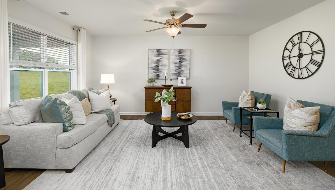 Open living room with ceiling fan and large window. New Home in Charlotte, North Carolina